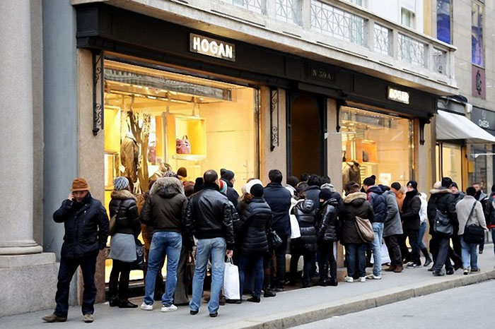MILAN, ITALY - JANUARY 04: Shoppers wait in line to enter a store on January 4, 2010 in Milan, Italy. Retailers are offering large discount prices to encourage after Christmas spending. (Photo by Vittorio Zunino Celotto/Getty Images)